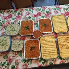 I can prepare large batches of my Continental dishes for your parties and gatherings. This spread includes trays of spaghetti in a rich tomato sauce, Shepherd's Pie, and a creamy mushroom side dish.