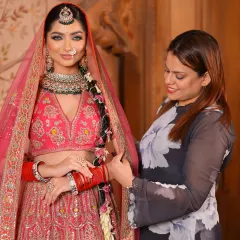 Here I am adjusting the dupatta for this beautiful bride. Ensuring the draping is perfect is a crucial step in creating a flawless and complete bridal look.
