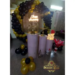A sophisticated black and gold theme featuring a balloon arch, a gold shimmer backdrop, and a 'Happy Birthday' neon sign.