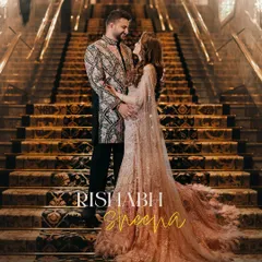 An engagement portrait on the grand staircase of a luxury hotel, capturing the couple in their exquisite traditional attire. This shot embodies the regal elegance and grandeur of a modern Indian love story.
