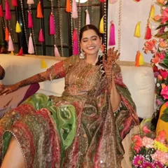 A happy bride showing off her henna against the colorful tassel backdrop I created. My goal is to design spaces that are not just beautiful but also perfect for capturing joyful memories.