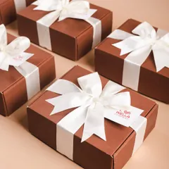 A collection of the finished Wella gift boxes, ready to be sent out. The clean, uniform look is perfect for professional corporate gifting.