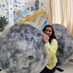 In the studio with a pair of custom moon murals before they head to their new home. Each one is handcrafted, ensuring no two pieces are exactly alike.