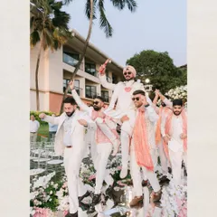 The groom's grand entry with his baraat. Carried by his friends on a mirrored aisle, this shot is full of energy, style, and the celebratory spirit of a Goan wedding.