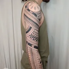 This full, freehand Maori sleeve is a testament to cultural storytelling through ink. Each pattern is drawn directly onto the skin to flow with the body's form, representing a unique journey of strength and heritage.