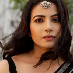 A powerful close-up where the focus is entirely on the expression. The traditional silver jewelry adds a layer of character, but the direct gaze is what holds the attention, making it an ideal headshot for an actor.