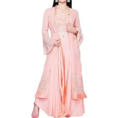 An elegant peach-colored indo-western set featuring dhoti-style pants, an embroidered bustier, and a matching longline jacket with bell sleeves. This is a high-fashion choice for a stylish wedding guest.