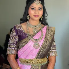 Pavitra looking stunning for her reception. Her makeup is a perfect balance of modern glam and elegance, paired with a beautiful pink and purple silk saree.