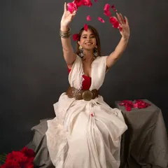 A moment of joy and celebration during our saree brand shoot. The model tossing rose petals adds a dynamic and festive feel to the portrait.