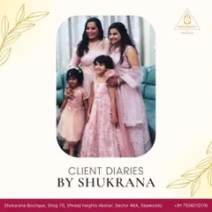 A family portrait from our client diaries, featuring four family members in coordinated light pink ensembles. We designed each outfit, from the little girl's frock to the elegant suits, to create a harmonious and beautiful family look.
