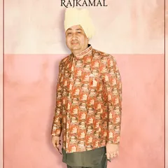 A client wearing a unique printed bandhgala jacket over a dark kurta, paired with a traditional turban. This shows how I can style distinctive looks for the entire wedding squad.