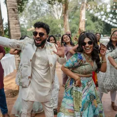 The couple letting loose on the dance floor with their friends. We capture the fun, high-energy moments of your celebration, showing everyone having a great time.
