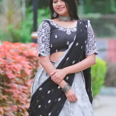 Modeling a stunning black and silver lehenga. The intricate embroidery on the blouse and the flowing skirt create a look that is both modern and glamorous.