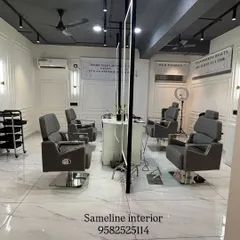 A look at the main cutting section of our East Patel Nagar salon project. We designed this space with custom-lit mirrors, clean marble-finish flooring, and elegant wall mouldings to create a high-end, professional atmosphere for clients.