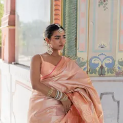We are in our silk saree Banaras mood. This baby pink silk saree is a classic and elegant choice.