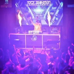 I don't just play the vibe, I am the vibe. Standing at the helm at Hydra with fire effects blazing, this image captures the intensity and control I bring to the console.
