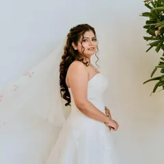 Soft curls, dreamy skin, and that classic white dress moment. A timeless bridal look that felt as graceful as it looked.