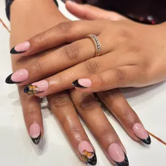A modern take on the French manicure. We created a sharp black tip and added a beautiful, hand-painted monarch butterfly accent nail for a touch of nature-inspired elegance.