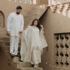 A couple descends the steps of a traditional mud-brick house in Punjab. The earthy tones and traditional attire create a timeless and culturally rich pre-wedding portrait.