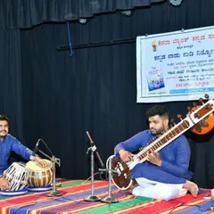 Performing live on stage with a talented tabla accompanist. This is the classic setup for a traditional Hindustani music performance, ideal for cultural events or anyone seeking an authentic baithak experience.