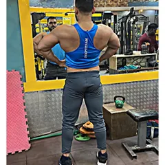 A lat spread pose, which emphasizes the width of the back. Exercises like wide-grip pull-ups and lat pulldowns are key for developing this V-taper.