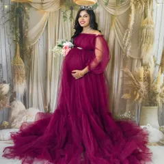 Welcome to our cozy studio. Here, we can create any look you dream of, like this elegant boho-chic setup with a stunning off-shoulder magenta gown and a delicate tiara for that perfect queen-mother feeling.