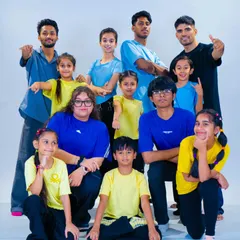 The whole crew together. This is our fam, a mix of instructors and students of all ages, striking a b-boy and b-girl pose after a great session in the studio. We welcome everyone to join our community.