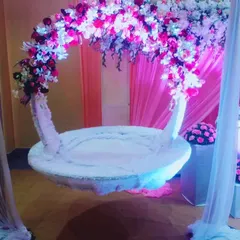 For a beautiful naming ceremony, we created this custom floral swing or 'jhula'. The design combines a dense arch of pink and white flowers with soft, elegant draping to create a magical focal point.