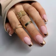 A modern and luxurious French manicure. This design uses a matte pink base with a striking rose gold chrome tip on a sharp square shape. The mix of matte and metallic textures creates a truly high-fashion look.
