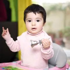 A sweet moment of a baby playing with a toy in her walker. These photos from an at-home session will be a wonderful reminder of what life was like during these precious early years.