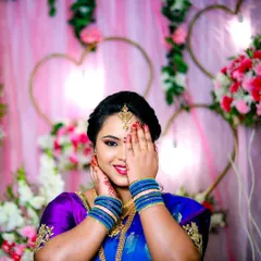 A beautiful portrait of the bride-to-be at her engagement. The pose highlights her ring and her stunning traditional attire against a lovely pink and floral background.