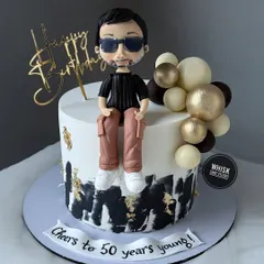 Cheers to 50 years young. This milestone birthday cake features a cool, custom figurine modeled on the birthday boy himself.