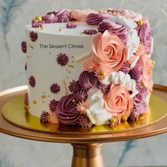 This is a custom tall cake with beautiful floral piping work in shades of peach and purple. It's a chocolate truffle cake, combining rich flavor with an elegant design for a truly special birthday.