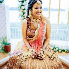 A radiant bride-to-be at her Haldi ceremony. We focus on capturing beautiful portraits even amidst the fun, showcasing the bride's happiness at the Moongate Scenic Wedding Venue in Bangalore.