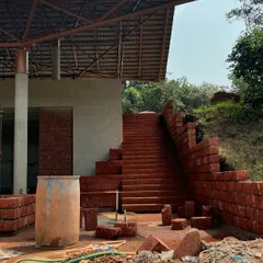 The pool pavilion at the yoga resort nearing completion. Built with local laterite stone, it is tucked under a stage pavilion to create a private yet open space for relaxation.