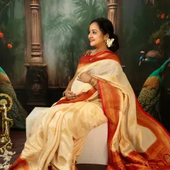 There is a divine grace in motherhood. For this traditional maternity portrait, we used a beautiful silk saree and classic props to create a timeless image. This solo shot focuses on the mother's serene profile and the elegant drape of the fabric over her baby bump.