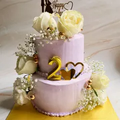 Celebrating two years together with this beautiful two-tier butterscotch cake. We decorated this lavender anniversary cake with fresh white roses, baby's breath, and gold accents for a touch of romance.