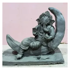 This 'Bappa on the Moon' is a popular custom design. The entire piece, from the base to the tip of the moon, is sculpted by hand, making it a special, one-of-a-kind handmade idol for your home.