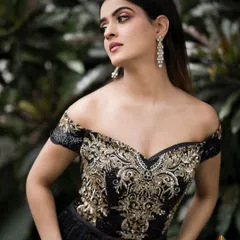 This image demonstrates my work with modern, high-fashion looks. The off-shoulder gown with intricate gold embroidery is the star, and I used natural, diffused lighting against a dark green backdrop to make the details pop and create a moody, elegant portrait.
