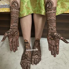 A beautiful composition of full hand and feet mehndi, showcasing traditional peacock and floral motifs in a harmonious design.