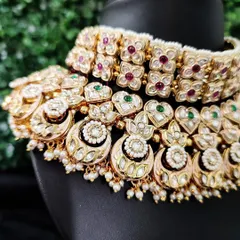 A close-up view of the intricate kundan work and colorful stones on this classic bridal choker.