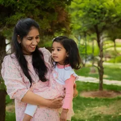 A tender moment between a mother and her daughter in a sunlit park. I focus on capturing the natural interactions and love that define your family's bond.