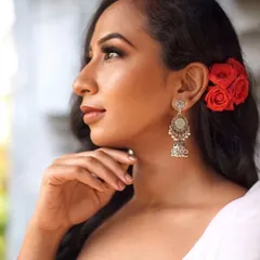 A beautiful close-up profile. This shot highlights the flawless skin, soft contour, and defined eye makeup, demonstrating a look that is perfect for editorial or portrait photography.