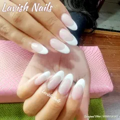 A classic French manicure on almond-shaped nails, a universally flattering and sophisticated choice for any bride.