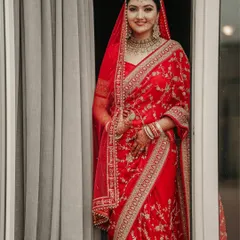The radiant bride. We take time to create stunning bridal portraits that capture the elegance, grace, and anticipation of the wedding day. This portrait showcases the intricate beauty of traditional Indian wedding attire.