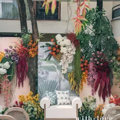 The 'Garden of Gaia' theme brought to life for a vibrant baby shower. This lush floral backdrop, bursting with tropical blooms and rich textures, transforms a backyard into a sacred, celebratory space for the mom-to-be.