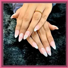 A beautiful example of a classic French manicure with delicate white daisy art on the accent nails.
