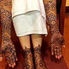 This is our complete bridal mehendi service, with rich, dark henna stain covering hands to elbows and feet. The cohesive design features beautiful rose motifs and demonstrates the full, stunning effect for your big day.