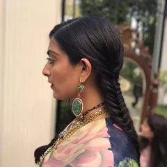 A side view of the fishtail braid, showing the detailed weaving technique. This style works wonderfully to showcase hair texture and length, creating a look that is both relaxed and stylish.