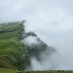 A stunning view of the Netravathi peak emerging from the clouds. Moments like these are why we call it trekking above the clouds.